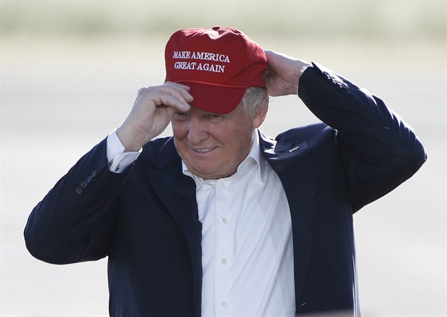 In this June 1, 2016, file photo, Republican presidential candidate Donald Trump wears his "Make America Great Again" hat at a rally in Sacramento, Calif.