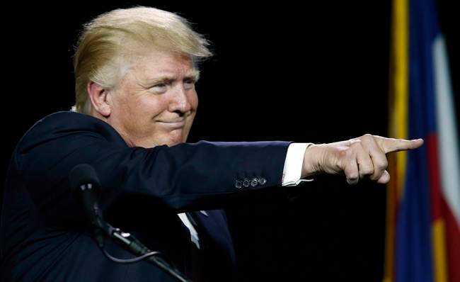 In this July 1, 2016, photo, Republican presidential candidate Donald Trump points to supporters during the opening session of the Western Conservative Summit in Denver. 