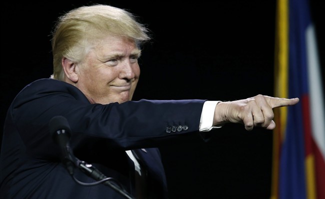 In this July 1, 2016, photo, Republican presidential candidate Donald Trump points to supporters during the opening session of the Western Conservative Summit in Denver. 