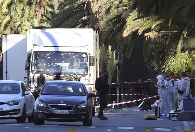 The truck which slammed into revelers late Thursday, July 14, is seen near the site of an attack in the French resort city of Nice, southern France, Friday, July 15, 2016. France has been stunned again as a large white truck mowed through a crowd of revelers gathered for a Bastille Day fireworks display in the Riviera city of Nice. (AP Photo/Luca Bruno)