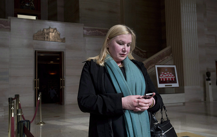 Wendy Cukier reads a message on her smart phone as she stands in the foyer of the Supreme Court of Canada in Ottawa, Friday March 27, 2015.