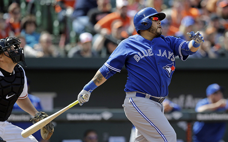 Toronto Blue Jays' Dioner Navarro watches his sacrifice fly ball in the fourth inning of a baseball game against the Baltimore Orioles, Sunday, April 12, 2015, in Baltimore. 