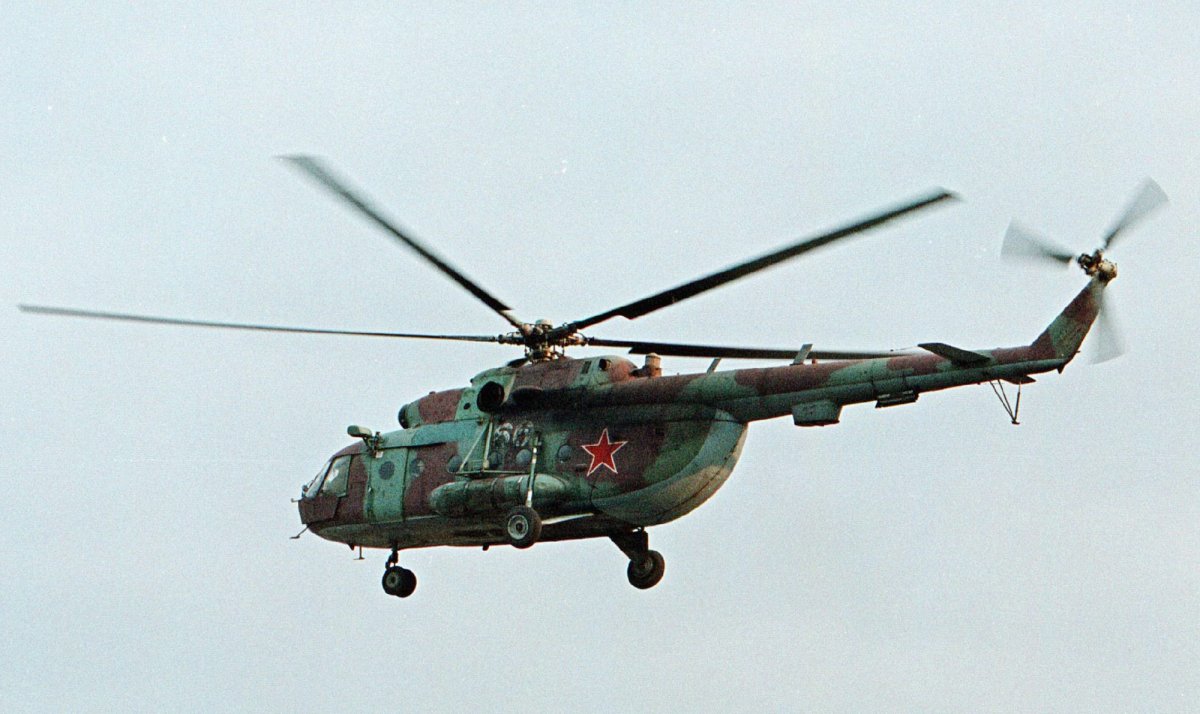 FILE In this in this Sept. 18, 2002 file photo a Mi-8 helicopter flies over the Chechen regional capital Grozny, Russia. A helicopter similar to the one pictured has been shot down in Syria and Russian President Vladimir Putin's spokesman says all people aboard it have been killed, Monday, Aug. 1, 2016. 