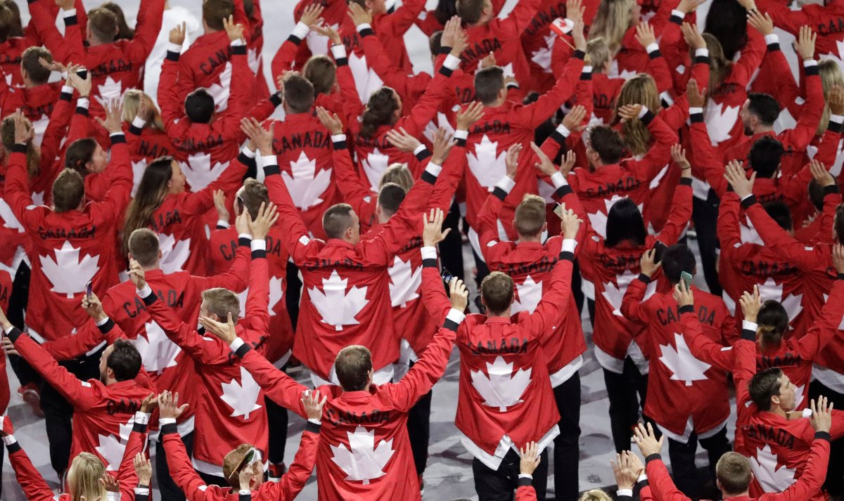 Team Canada wave as they walk into the stadium during the opening ceremony for the 2016 Summer Olympics in Rio de Janeiro, Brazil, Friday, Aug. 5, 2016. 