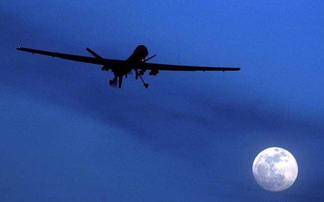 An unmanned U.S. Predator drone flies over Kandahar Air Field, southern Afghanistan, on a moon-lit night. 