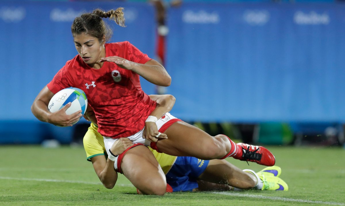 Canada's Bianca Farella, front, scores a try as Brazil's Claudia Jaqueline Teles, tries to defend during the women's rugby sevens match between Canada and Brazil at the Summer Olympics in Rio de Janeiro, Brazil, Saturday, Aug. 6, 2016. 