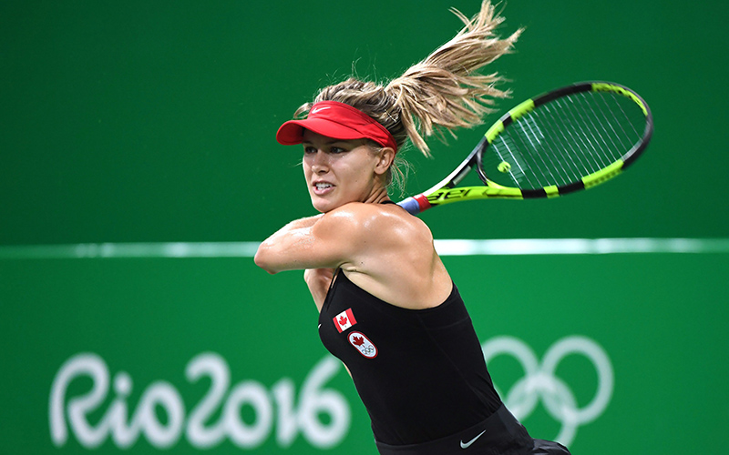 Canada's Eugenie Bouchard follows through after returning to Sloane Stephens, of the United States, in first round women's singles tennis at the 2016 Olympic Games in Rio de Janeiro, Brazil on Saturday, Aug. 6, 2016. 