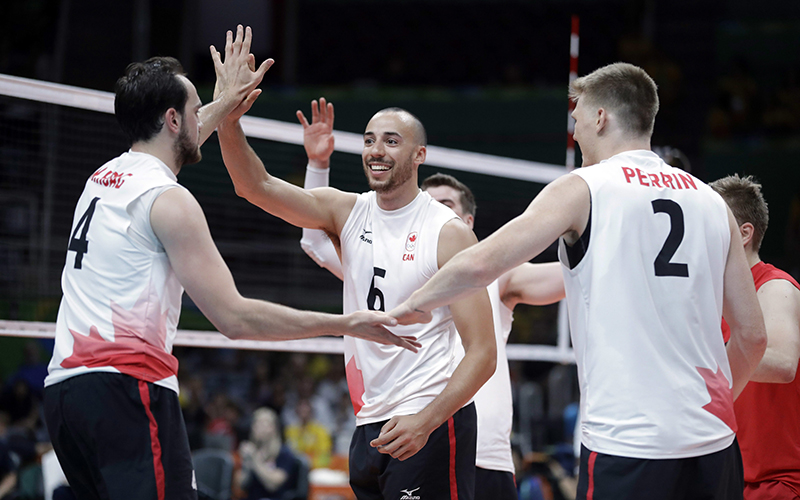 Members of team Canada celebrate during a men's preliminary volleyball match against the United States at the 2016 Summer Olympics in Rio de Janeiro, Brazil, Sunday, Aug. 7, 2016. 