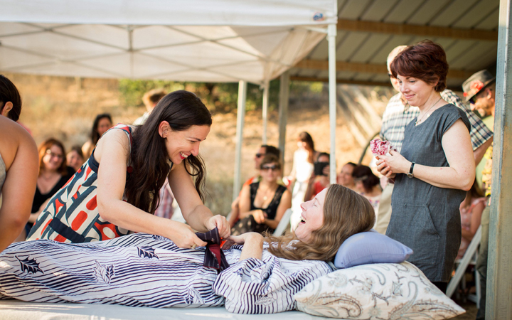 Amanda Friedland, left, adjusts her friend Betsy Davis's sash as she lays on a bed during her "Right To Die Party" in Ojai, Calif. 