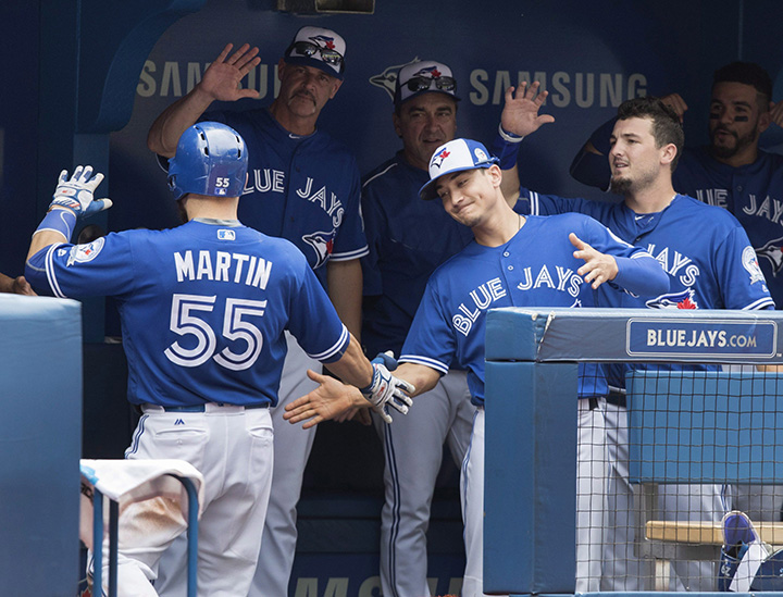 Toronto Blue Jays' Russell Martin comes into dugout after he hit a solo home run in the fifth inning of their American League baseball game against the Houston Astros in Toronto on Sunday.