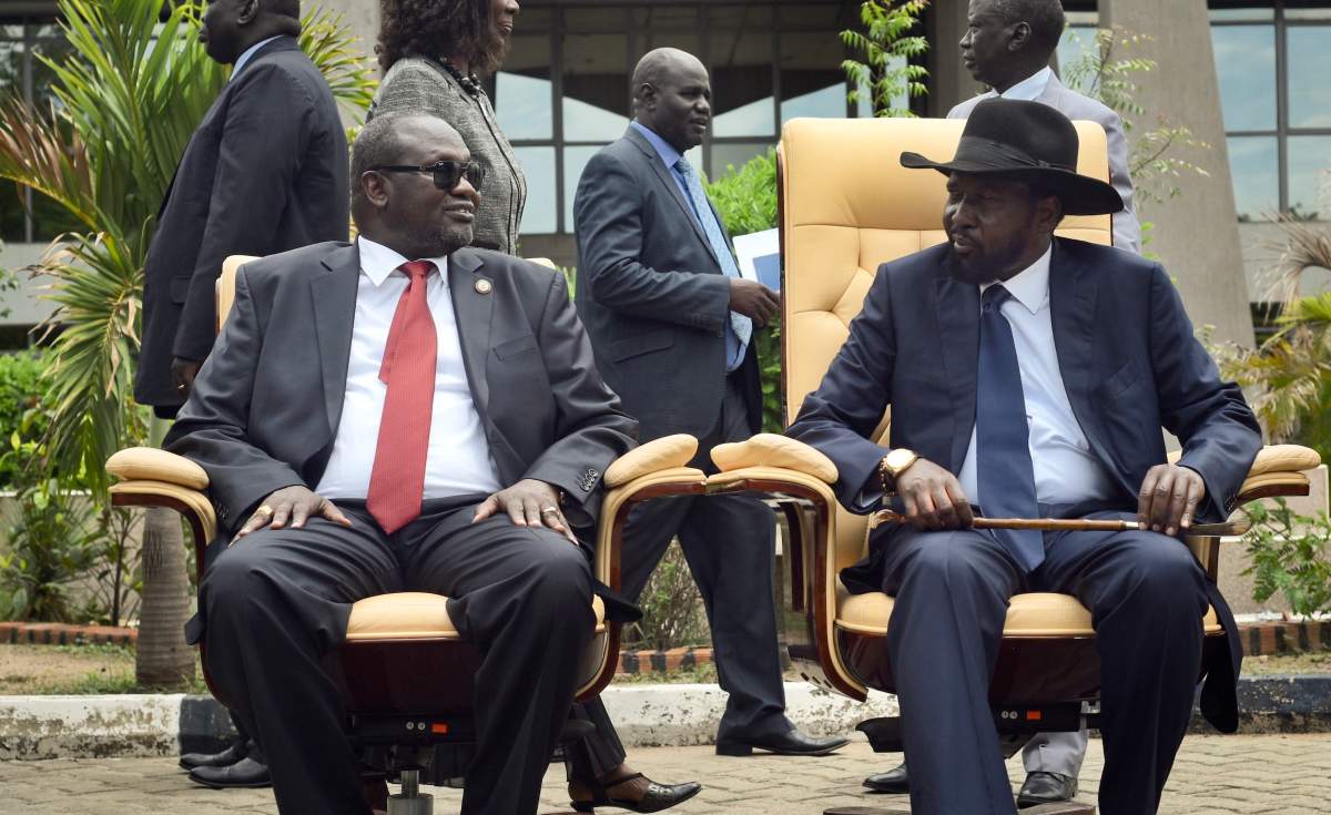 FILE – In this Friday, April 29, 2016 file photo, South Sudan’s then First Vice President Riek Machar, left, looks across at President Salva Kiir, as the two sit to be photographed following the first meeting of a new transitional coalition government, in the capital Juba, South Sudan. According to reports from victims which have come to light Monday Aug. 15, 2016, South Sudanese troops, fresh from winning a battle against opposition forces in the capital, Juba, on July 11, 2016, went on a nearly four-hour rampage through a residential compound popular with foreigners, and the U.N. peacekeeping force stationed nearby are accused of refusing to respond to desperate calls for help. (AP Photo/Jason Patinkin, File)