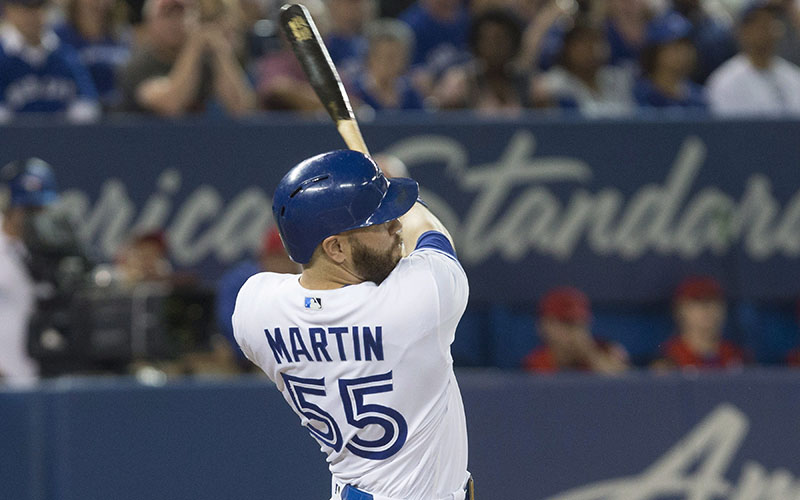 Toronto Blue Jays' Russell Martin hits a three run double against the Minnesota Twins during sixth inning Major League baseball action in Toronto on Friday August 26, 2016. 