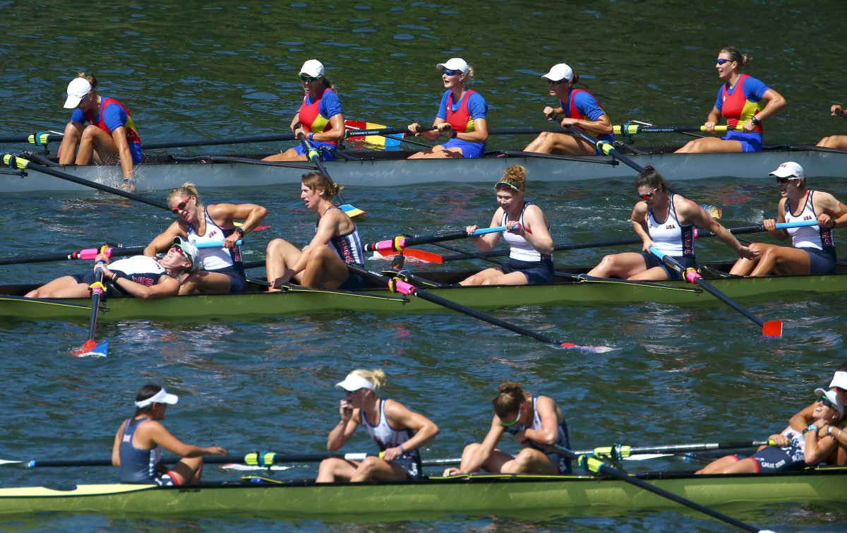 2016 Rio Olympics - Rowing - Final - Women's Eight Final A - Lagoa Stadium - Rio De Janeiro, Brazil - 13/08/2016. Bronze medalists, the Romania team, gold medalists, the US team and silver medalists, the Britisih team, react after the finish. 