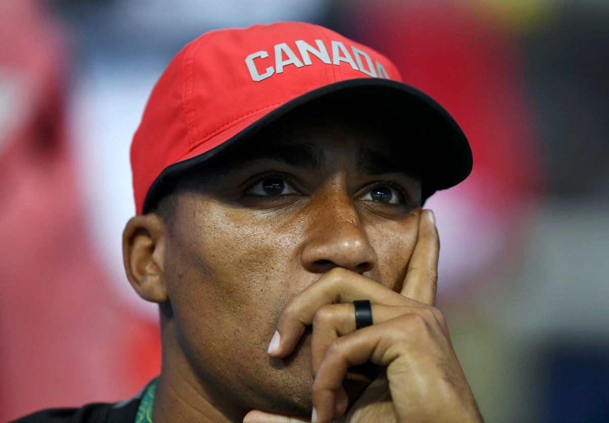 U.S. decathlete Ashton Eaton wears a Canada cap as he watches his wife Brianne Theisen Easton (CAN) of Canada during competition in Javelin group A women's heptathlon.