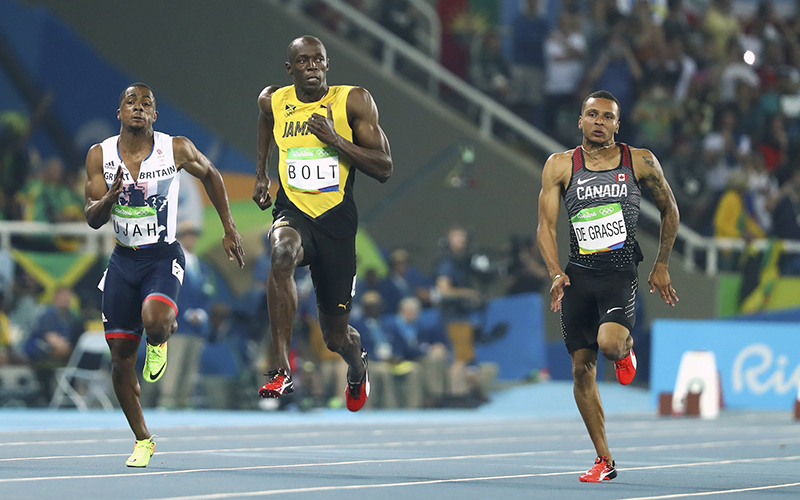 Usain Bolt of Jamaica, Andre De Grasse of Canada and Chijindu Ujah of Britain compete in the 100m semifinals.