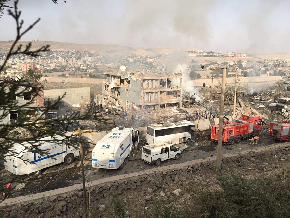 Turkish police and firefighters are parked near a damaged police headquarters after a car bomb killed eight Turkish police officers and injured 45 people on August 26, 2016 in Cizre, southeastern Turkey, an attack blamed on Kurdish militants, state media said.
         
