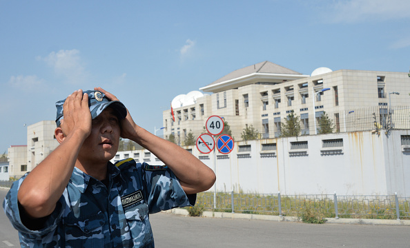 A Kyrgyz police officer patrols next to the Chinese embassy in Bishkek on August 30, 2016.