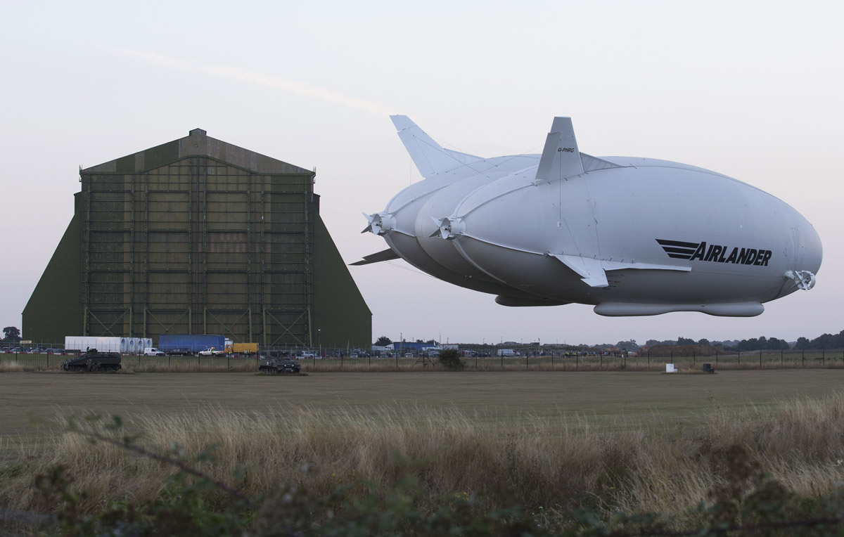 The Hybrid Air Vehicles HAV 304 Airlander 10 hybrid airship is seen preparing to land at the end of its maiden flight at Cardington Airfield near Bedford, north of London, on August 17, 2016.