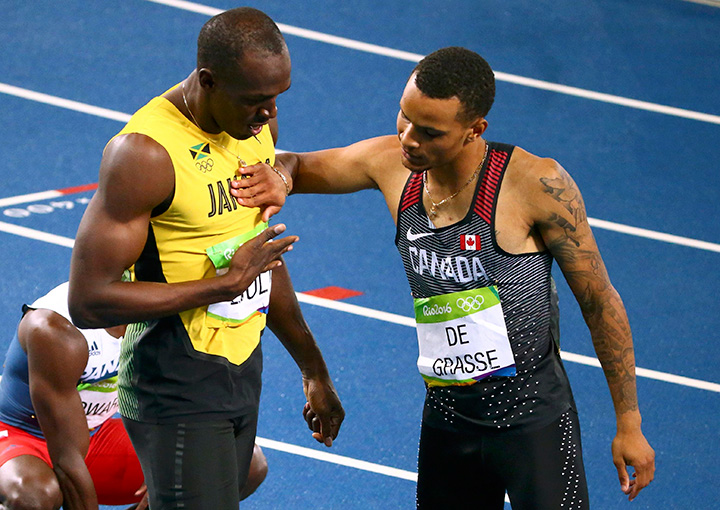 Jamaica’s Usain Bolt and Canada’s Andre De Grasse celebrate after the men’s 200-metre final at the Rio Olympics on August 18, 2016.