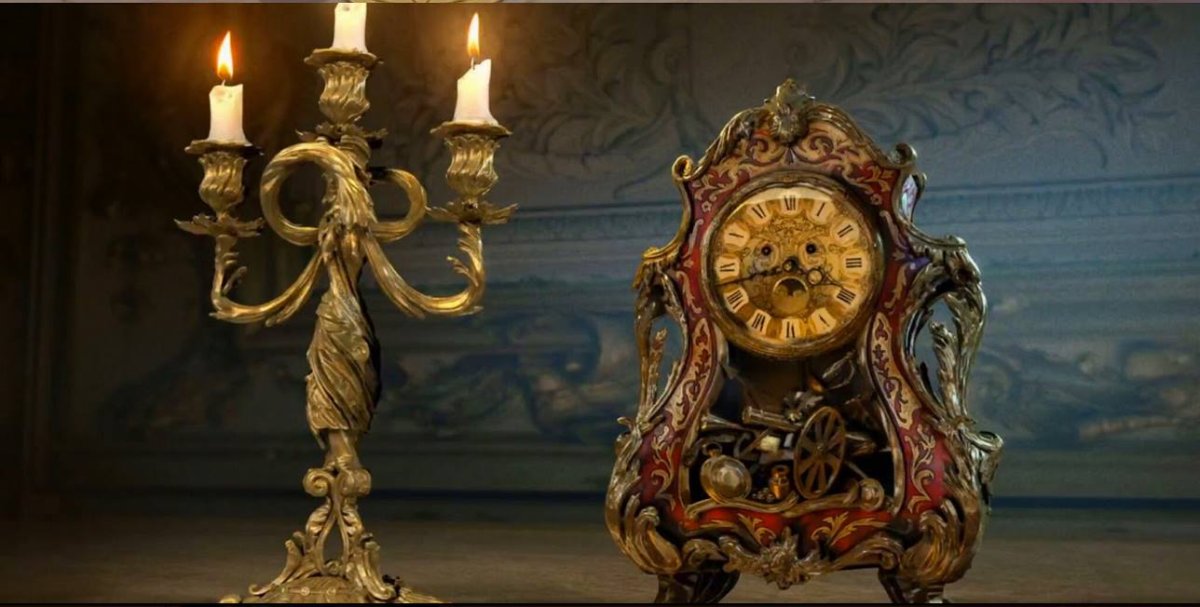 "These two, just standing there staring...
Here's a fine piece of concept art of Ewan McGregor as Lumière and Ian McKellen as Cogsworth. These designs are close but may not be final."
.