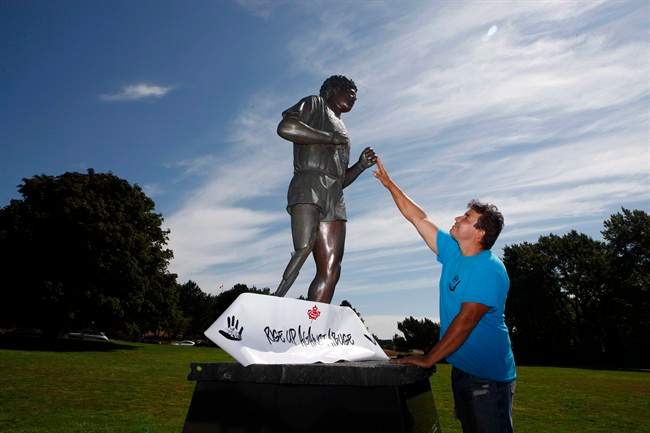 Conrad Burns, a Prince Albert resident, stands near the Terry Fox statue at Mile 0 in Victoria, B.C., Monday, August 8, 2016 after walking across the country. He started at Mile 0 in St. Johns, Nfld, April 1, 2016 to create awareness about abuse and violence.