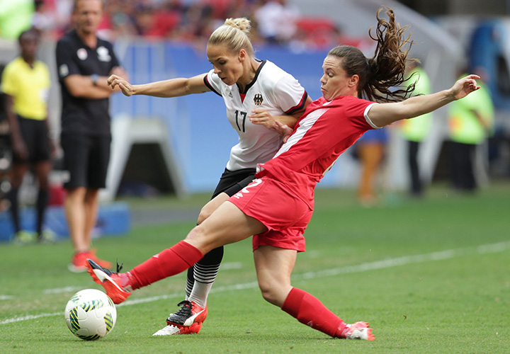 Canada's Allysha Chapman and Germany's Isabel Kerschowski fight for the ball during a Group F match of the women's Olympic football tournament between Germany and Canada at the National Stadium, in Brasilia, Brazil, Tuesday, Aug. 9, 2016. 