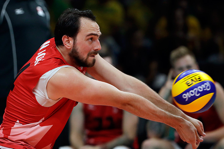 Canada's Nicholas Hoag passes the ball during a men's preliminary volleyball match against Italy at the 2016 Summer Olympics in Rio de Janeiro, Brazil, Monday, Aug. 15, 2016. 
