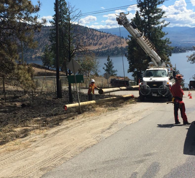 File Photo: BC Hydro crews replacing burned poles on Westside Road in Traders Cove this past summer.