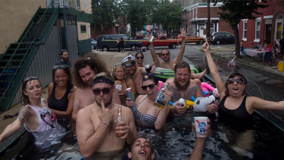 A photo showing Philadelphia residents swimming in a city dumpster.