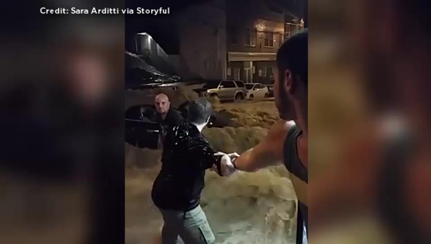 WATCH: Pedestrians form human chain to rescue woman stranded by flood ...
