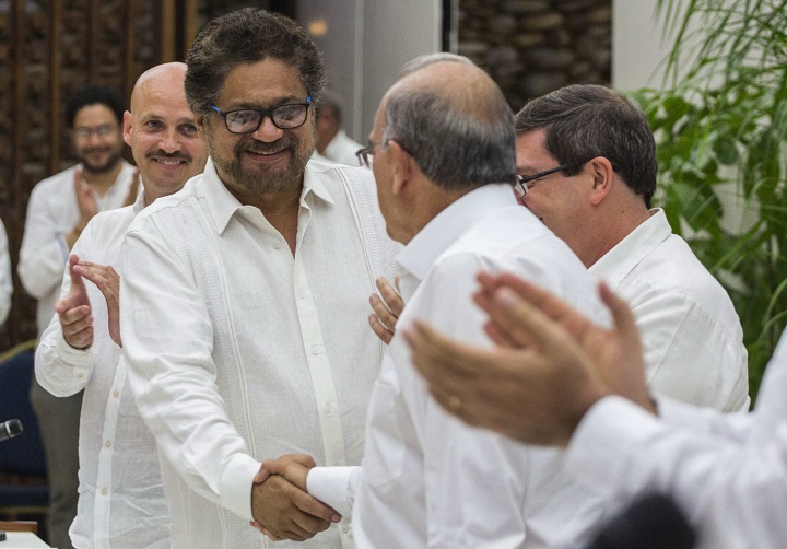 Humberto de La Calle, right, head of Colombia's government peace negotiation team shakes hands with Ivan Marquez, chief negotiator of the Revolutionary Armed Forces of Colombia after signing a peace agreement in Havana, Cuba, Wednesday, August 24, 2016. Colombia's government and the country's biggest rebel group reached a deal for ending a half-century of hostilities in what has been one of the world's longest-running armed conflicts.