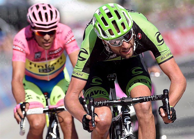 Ryder Hesjedal of Canada, right, crosses the finish line ahead of the overall leader Aberto Contador, left, at the end of the18th stage of the Giro d'Italia, Tour of Italy cycling race from Melide, Switzerland, to Verbania, Italy, Thursday, May 28, 2015. Hesjedal confirmed on Monday that he will retire at the end of the 2016 season.