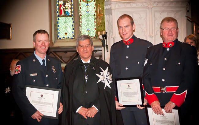 Andrew Vickers, second from left, poses for a photo with New Brunswick Lt.-Gov. Graydon Nicholas, second from right, in this 2012 handout photo. 