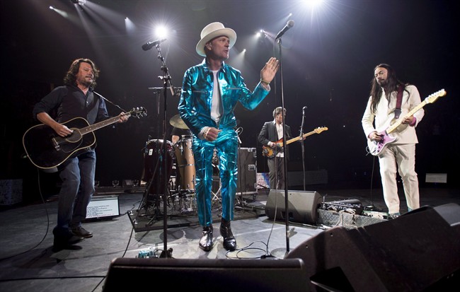 Frontman of the Tragically Hip, Gord Downie, centre, leads the band through a concert in Vancouver on July 24, 2016.
