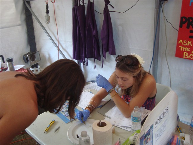 For the past 14 years, organizers of a giant electronic music festival on a British Columbia mountain ranch have quietly helped participants test their recreational drugs to find out what substances are inside. An ANKORS harm reduction volunteer is seen during the process of drug testing in their tent in this undated handout photo. 