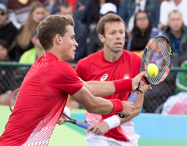 Canada's Daniel Nestor looks on as Vasek Pospisil returns a shot during their semifinal tennis doubles match against Spain's Rafael Nadal and Marc Lopez at the 2016 Summer Olympics Thursday, August 11, 2016 in Rio de Janeiro, Brazil. 