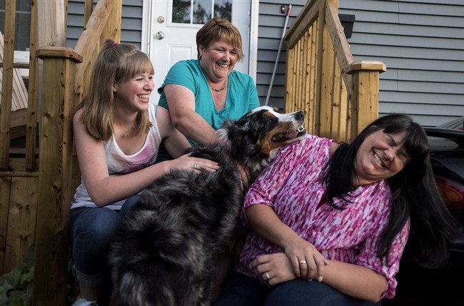 From left to right, Bronwyn Mengering, Dawn Mengering, and Debbie Johnson laugh while sitting with their dog Thor in Dartmouth, N.S. on Friday, August 19, 2016.