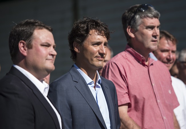 Prime Minister Justin Trudeau, centre, joins MP Colin Fraser, left, and Nova Scotia Premier Stephen McNeil during an event in Bridgetown, N.S. on Tuesday, August 16, 2016. 