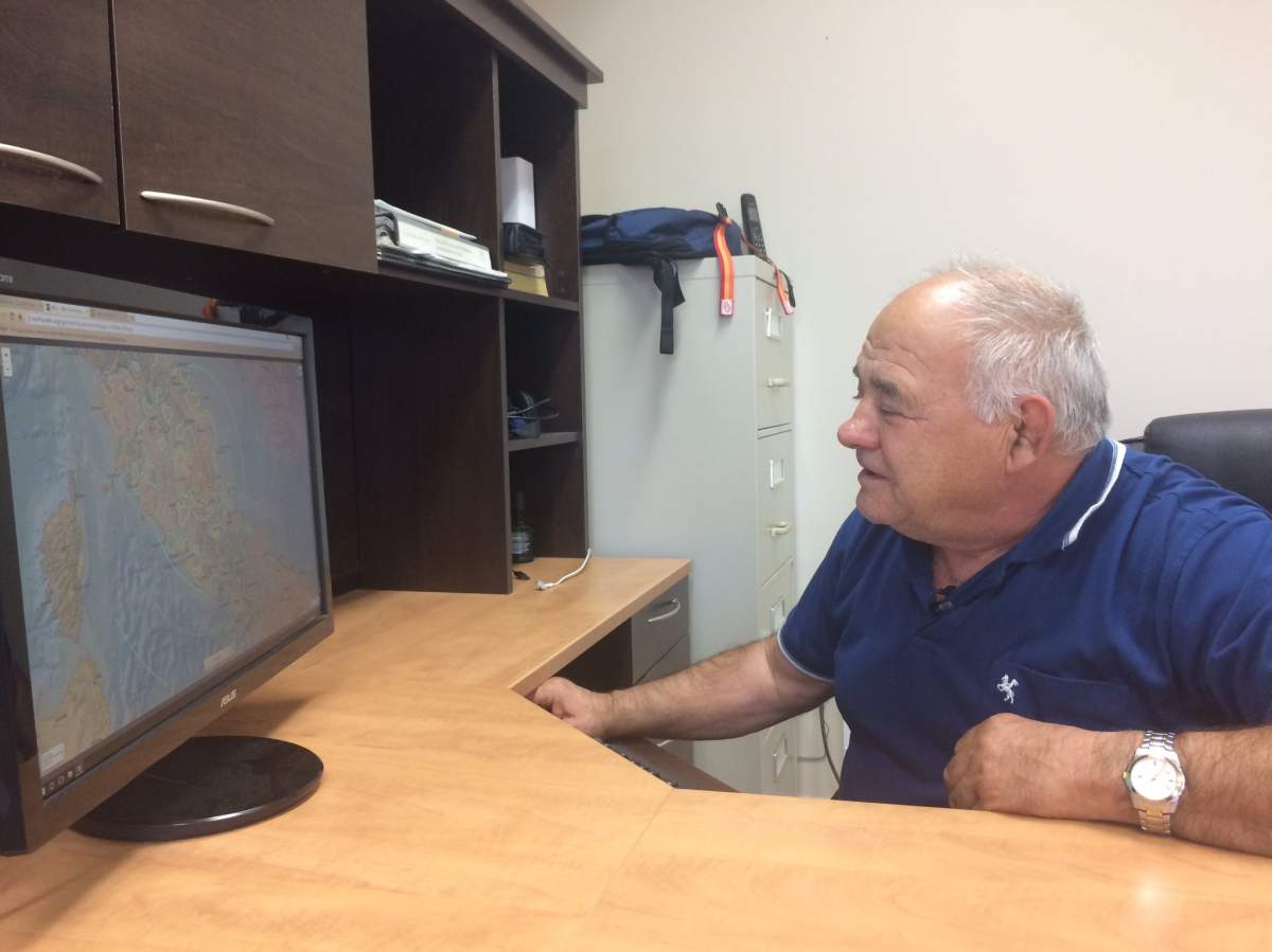 Honorary Vice-Consul of Italy Sebastiano Deiana maps out area where earthquake was hardest hit.