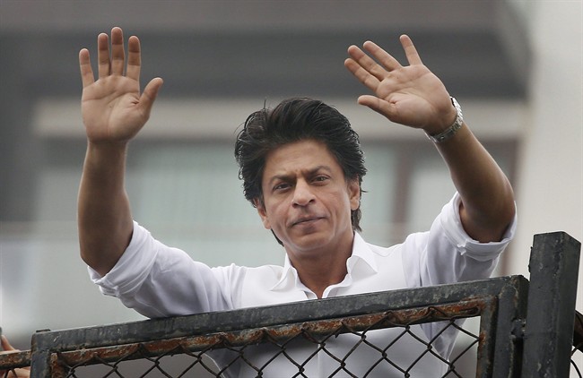 FILE - In this Thursday, July 7, 2016, file photo, Bollywood actor Shah Rukh Khan greets fans waiting outside his residence on Eid al-Fitr in Mumbai, India. Bollywood superstar Khan has tweeted that he gets detained at U.S. airports "every damn time" after he was stopped at the Los Angeles International Airport. The U.S. Ambassador to New Delhi Richard R. Verma tweeted an apology to the star Friday, Aug. 12, saying that the government was working to "to ensure it doesn't happen again." (AP Photo/Rajanish Kakade, File ).