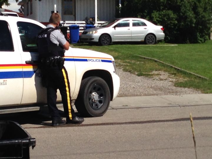 RCMP surrounded a house on 14 Street in Didsbury Friday, Aug. 12, 2016.
