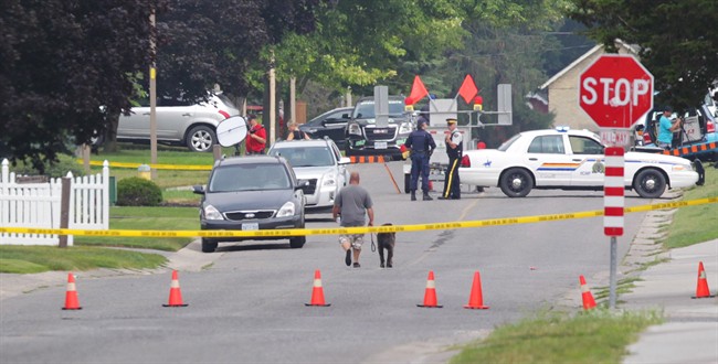 Police gather evidence outside of a house in Strathroy, Ont. on Aug. 11, 2016. Terrorism suspect Aaron Driver was killed in a confrontation with police in the southern Ontario town.