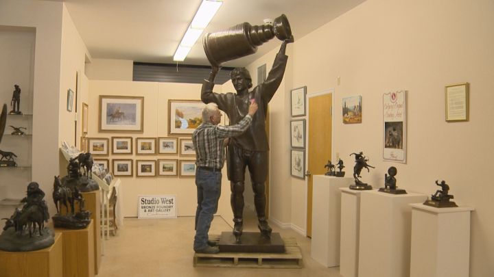 Bronzesmith Don Begg works to shine up a statue of Wayne Gretzky at his studio in Cochrane, Alta. on Aug. 25, 2016.