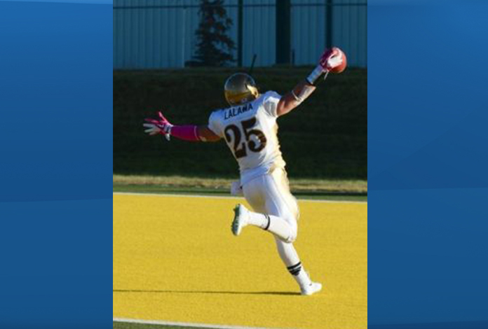 Manitoba Bisons linebacker DJ Lalama celebrates in the endzone after scoring a pick-six against Alberta in 2014.