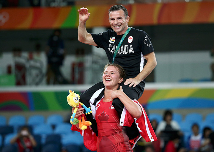 Canada’s Erica Wiebe celebrates with her coach after winning the gold medal in the women’s freestyle 75kg event on August 18, 2016.