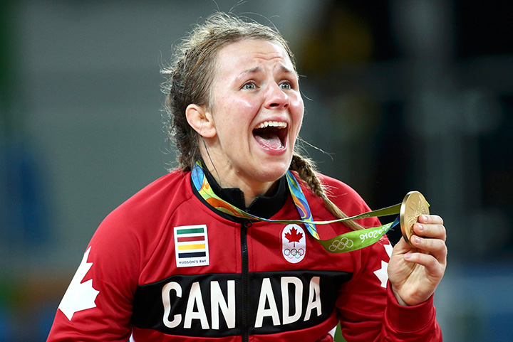 Canada’s Erica Wiebe reacts after receiving her gold medal in wrestling. 