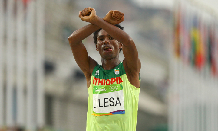 As Feyisa Lilesa crossed the finish line Sunday, he threw his arms over his head making an "X" in a show of support for members of his Oromo tribe.