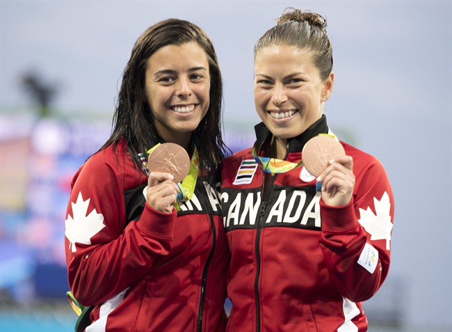 Canada’s Meaghan Benfeito (left) and Roseline Filion celebrate on the podium after their bronze medal win in women’s synchronized 10m platform diving at the 2016 Summer Olympics in Rio de Janeiro, Brazil, Tuesday, Aug. 9, 2016.