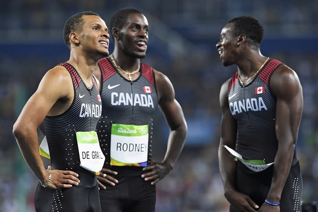 Canada's Andre De Grasse, left to right, Brendon Rodney and Aaron Brown watch the scoreboard following the men's 4x100-metre relay final at the 2016 Summer Olympics in Rio de Janeiro, Brazil on Friday, August 19, 2016.