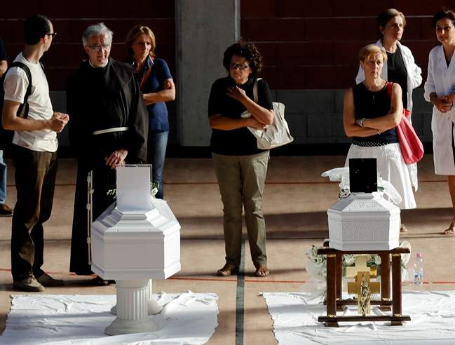 Coffins of some of the victims of Wednesday’s earthquake lie inside a gymnasium in Ascoli Piceno, Italy, Friday, Aug. 26, 2016.
